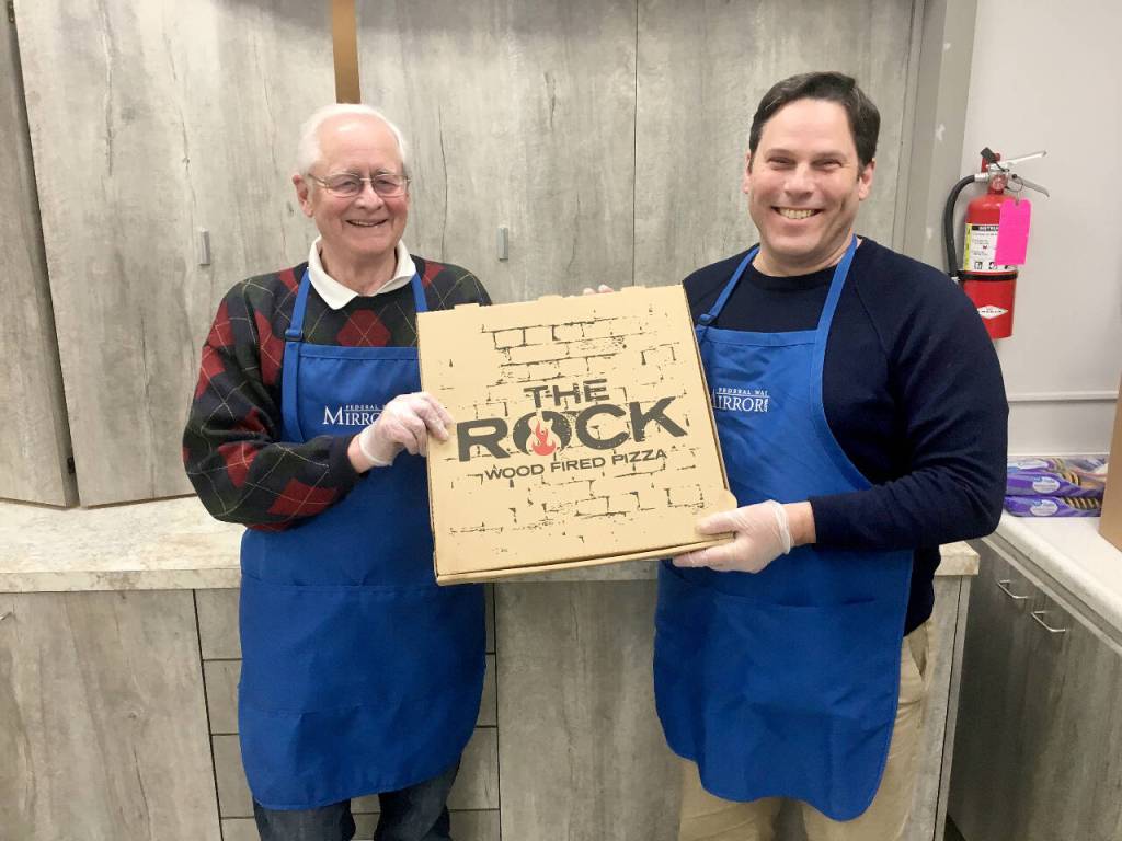 Bob Roegner, left, and Federal Way Mayor Jim Ferrell volunteer at a homeless shelter in 2019. File photo