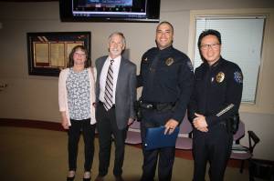 Bonnie and Steven Kness, Officer Wells and Chief Hwang. Photo provided by the city of Federal Way.