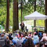 Kayla Guyett (Jicarilla Apache) shares a story about salmon in both English and Twulshootseed, the language of the Puyallup Tribe at one of the stations during the Storming the Sound with Salmon event. Photo by Keelin Everly-Lang / the Mirror