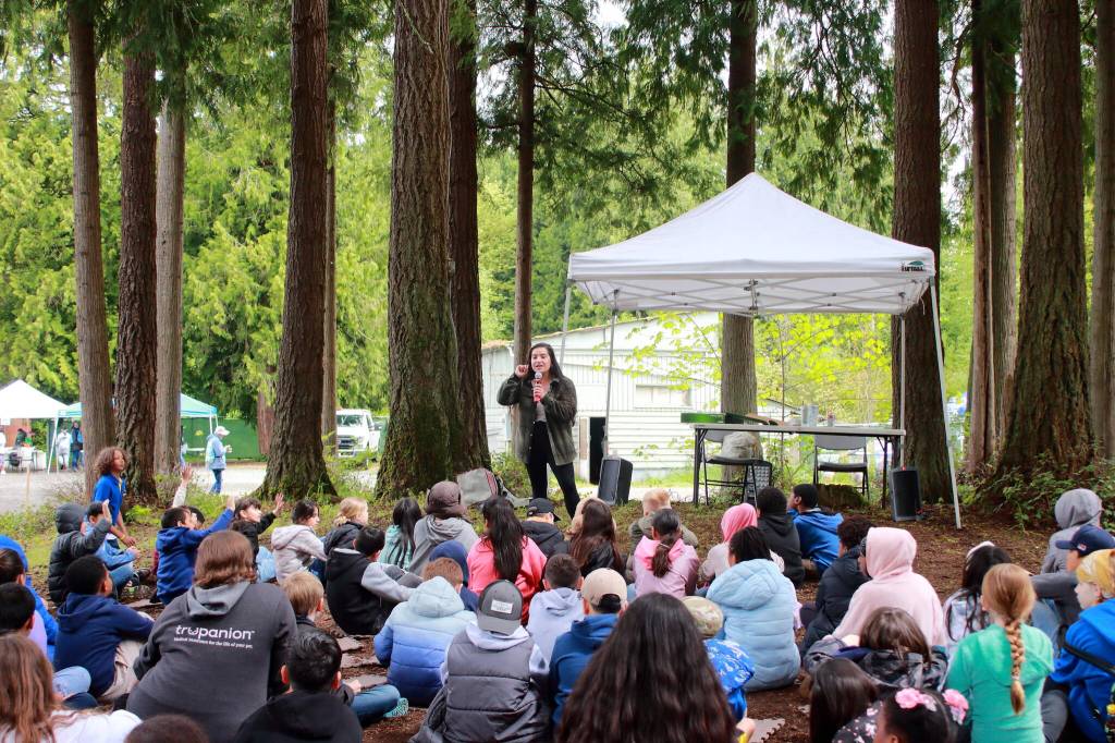 Kayla Guyett (Jicarilla Apache) shares a story about salmon in both English and Twulshootseed, the language of the Puyallup Tribe at one of the stations during the Storming the Sound with Salmon event. Photo by Keelin Everly-Lang / the Mirror