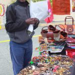 Vendor David Gitau sells a variety of locally made handcrafted jewelry, bags and art at the Federal Way Farmers Market on opening day May 10. Photo by Keelin Everly-Lang / the Mirror