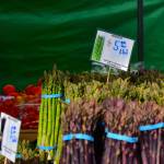 Seasonal spring produce was on display at the Federal Way Farmers Market on opening day May 10, like unique purple asparagus from local farms. Photo by Bruce Honda