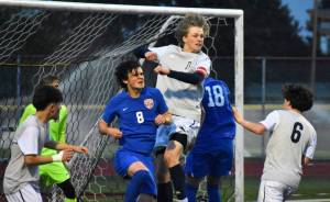 Dylan Lang makes a clearing header on a corner kick for Decatur. Ben Ray / The Mirror
