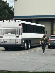 An ICE bus at Eagle Beverage in Kent to transport 17 employees arrested Tuesday, May 20. COURTESY PHOTO, Luis Cortes-Romero