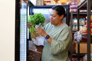 Rosi Bolatagici is the Pasifika Food Networks Manager at the Pacific Islander Community Association of Washington (PICA-WA). Here she shows off some fresh, locally grown produce that is available at their pantry to support community members facing food insecurity. Photo by Keelin Everly-Lang / the Mirror