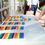 City employees pick up a Pride flag on their way into work after the flag raising event on June 2 at City Hall. Photo by Keelin Everly-Lang / the Mirror