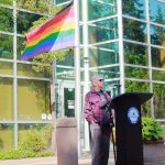 Catherine North speaks at the Pride flag raising on June 2 at City Hall. She and her wife were one of the first same-sex couples to get married in Washington state after it was legalized, and they have lived in Federal Way for over 30 years. Photo by Keelin Everly-Lang / the Mirror