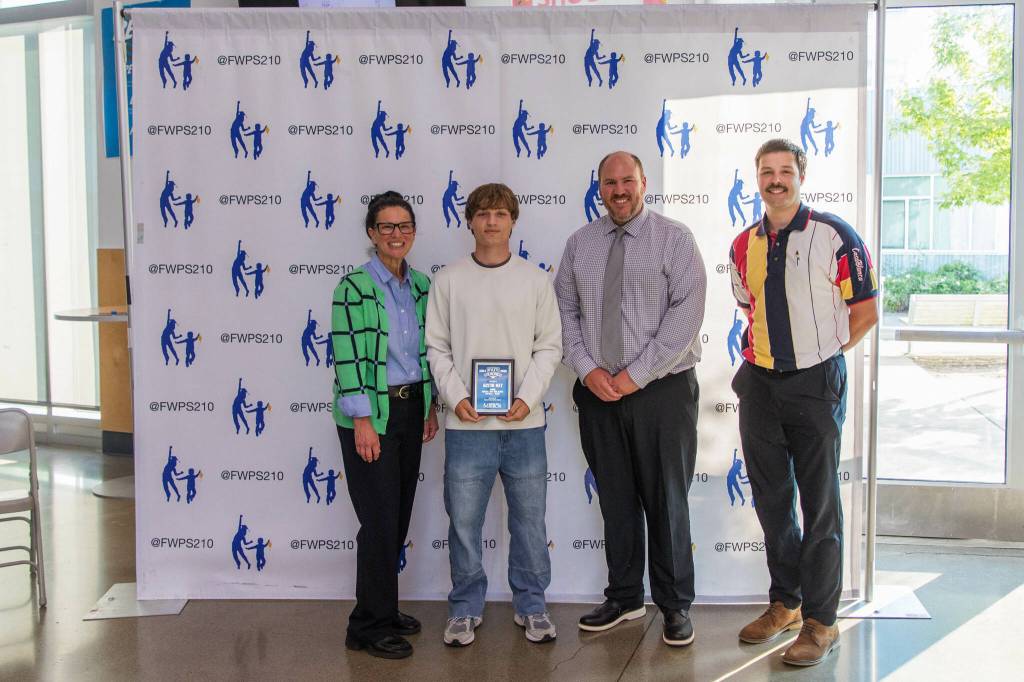 Austin May stands with Dr. Dani Pfeiffer (left), Federal Way Director of Equity and Athletics John Yellam (center right) and Federal Way Mirror Sports Reporter Ben Ray (far right). Photo provided by FWPS.
