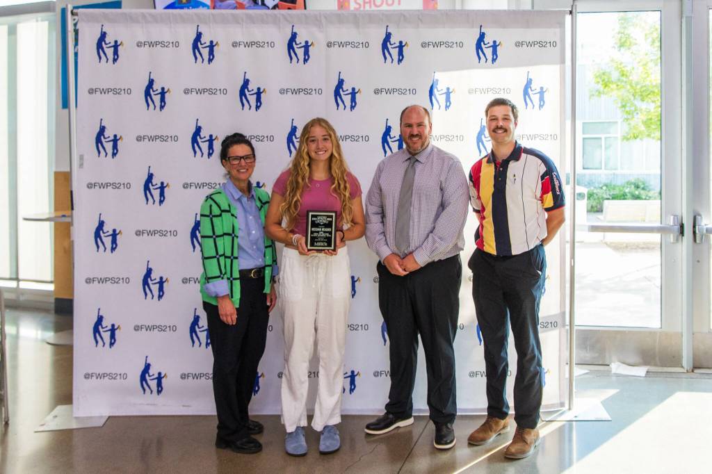 Meeghan Meagher stands with Dr. Dani Pfeiffer (left), Federal Way Director of Equity and Athletics John Yellam (center right) and Federal Way Mirror Sports Reporter Ben Ray (far right). Photo provided by FWPS.