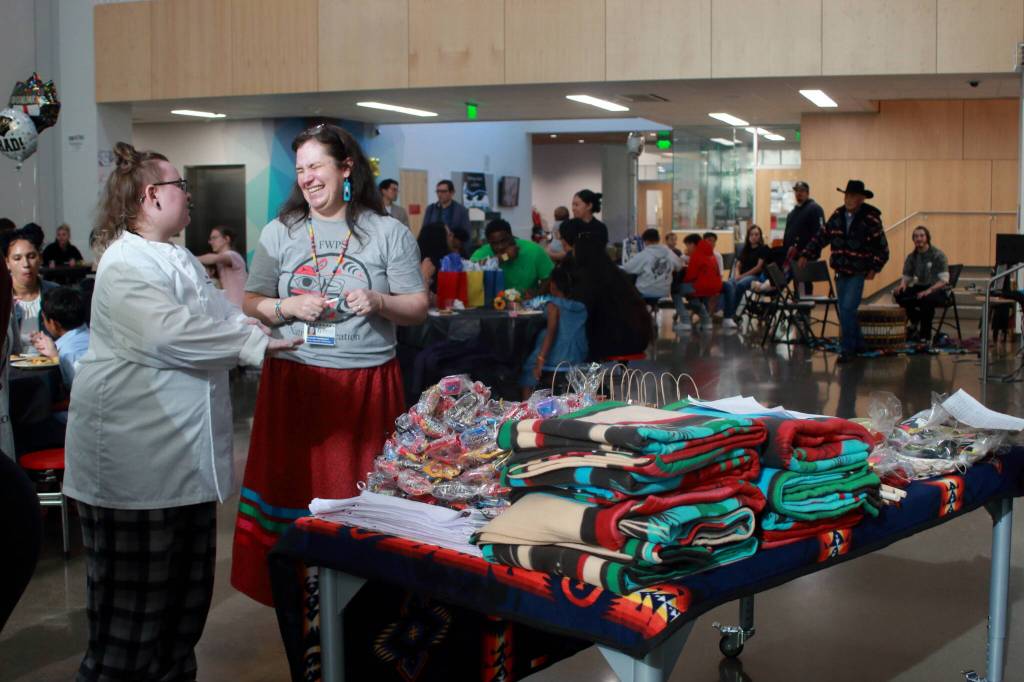 Amanda Rambayon laughs with a ProStart intern who helped prepare dinner at the Native Graduation event on May 29. Photo by Keelin Everly-Lang / the Mirror.