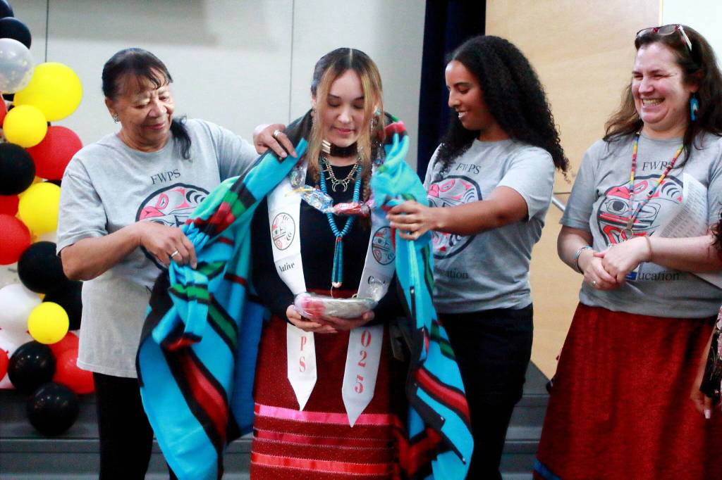 Graduating seniors were wrapped in a blanket as part of the celebration at the Native Graduation for FWPS. Photo by Keelin Everly-Lang / the Mirror