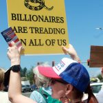 Demonstrator Andrea Paine brought pocket-size editions of the United States Constitution to hand out at the protest on June 14 in Federal Way. Photo by Keelin Everly-Lang/the Mirror