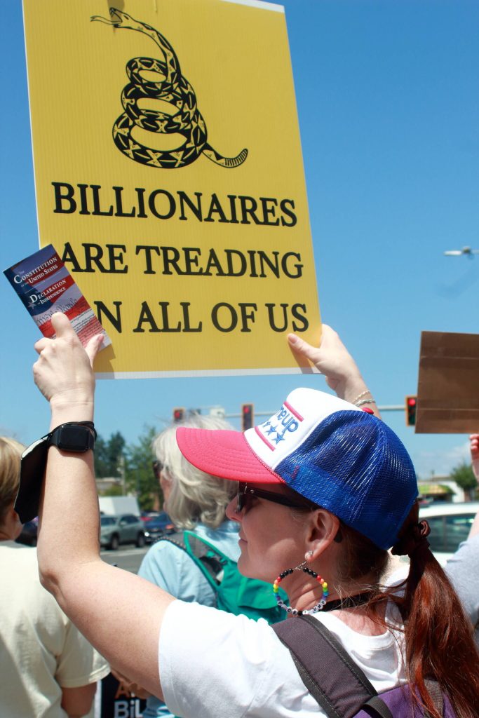 Demonstrator Andrea Paine brought pocket-size editions of the United States Constitution to hand out at the protest on June 14 in Federal Way. Photo by Keelin Everly-Lang/the Mirror
