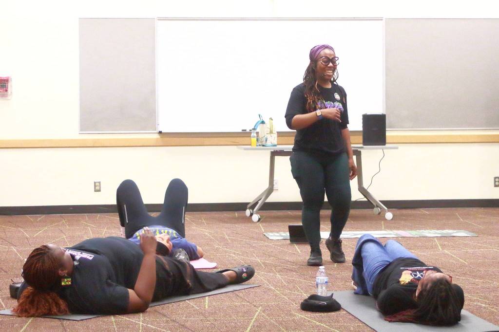 Dr. Ayanna Gore leads a Flex and Flow workshop highlighting the importance of self care at the Juneteenth event in this activity offered by the Trap Lab in Federal Way. Photo by Keelin Everly-Lang / the Mirror.
