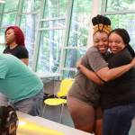 The theme of the community mural was family reunion and the painting party included this moment of joy between Jeneva and her mom. Photo by Keelin Everly-Lang / the Mirror.