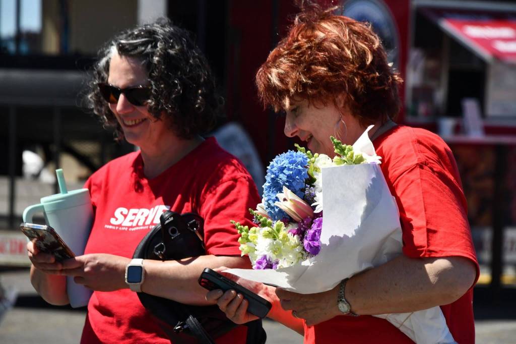 Volunteers pick up some bouquets of flowers at the Federal Way Farmers Market after a busy morning of volunteering. Photo courtesy of We Love Our City Federal Way