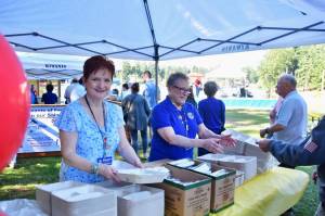 Janice Siebenaler and Linda Persha greet guests at the Federal Way Kiwanis Clubs annual Salmon Bake fundraiser July 25 at Steel Lake Park. Proceeds benefit local community organizations and programs. Photo by Bruce Honda