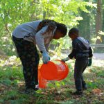 Older youth volunteers helped younger ones to water native plants that were planted at past AYDEPI events. Photo by Keelin Everly-Lang / The Mirror