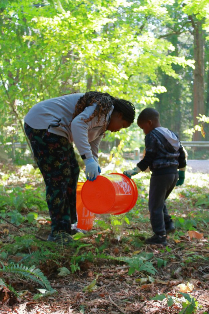 Older youth volunteers helped younger ones to water native plants that were planted at past AYDEPI events. Photo by Keelin Everly-Lang / The Mirror