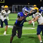 Federal Way junior Zamarie Tellez stiff-arms a Ferndale player. Ben Ray / The Mirror