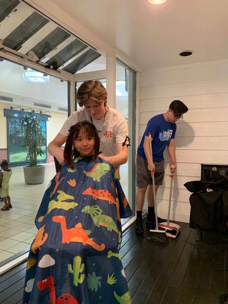 The whole Federal Way community gets together to make sure kids get to start the school year with a fresh cut, whether that is from the Tables event like in this picture, or at the large free haircutting event put on by the city and local salons and barbershops in Town Square Park. Photo provided by the Table.