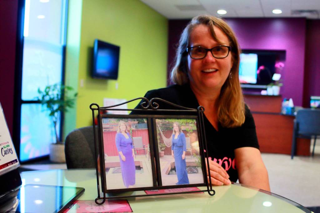 Sharon Gentry shows photos of herself when she first started her fitness journey at Curves, before she became the local franchise owner. Photos by Keelin Everly-Lang / the Mirror