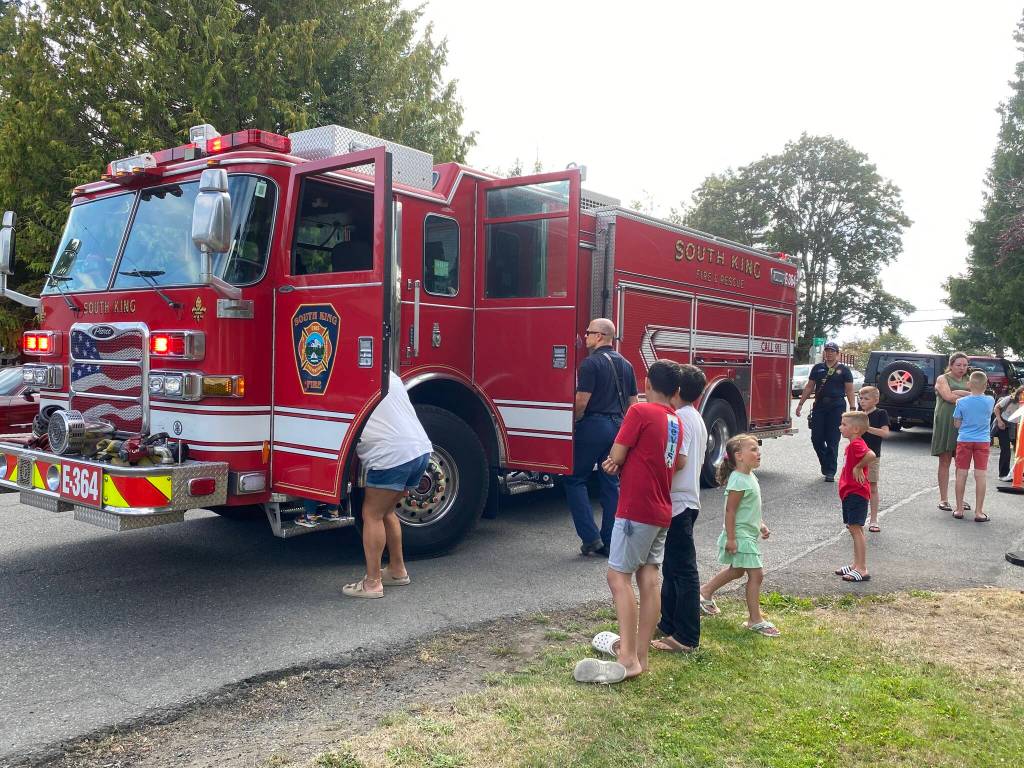 Folks at the Laurelwood Garden Apartments check out a South King Fire truck during National Night Out festivities.