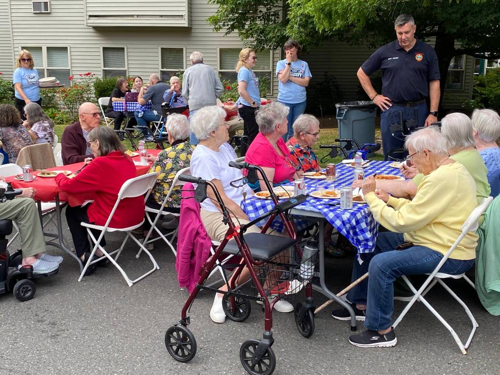 Residents at Village Green chat with each other and South King Fires Brad Chaney. Photos by Mariah Hill/For the Mirror