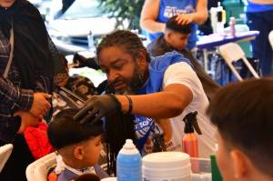 Lamont Styles offers free haircuts at the annual Back 2 School Free Haircuts event on Aug. 22. Photos by Bruce Honda