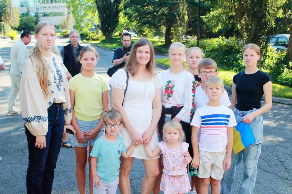 Lesia Vsach and her nine children moved to Federal Way from Ukraine a year ago and shared through a translation app that seeing the flag in Federal Way brings a feeling of home, seeing a part of yourself and a part of your life there in Ukraine. Photos by Keelin Everly-Lang / the Mirror