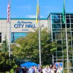 Ukrainian community members and local leaders pose with the Ukrainian flag after it is raised for the first time at city hall. Photos by Keelin Everly-Lang / the Mirror