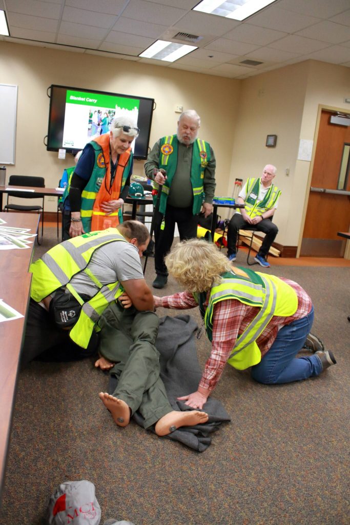 Volunteer students learn about how to use a blanket to carry someone who is injured or cant move on their own at a CERT Basic Course in 2024. Photos by Keelin Everly-Lang / the Mirror