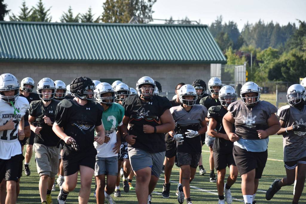 Kentwood players rally during team conditioning. Photo by Ben Ray/Sound Publishing