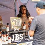 Gail Thompson, owner of Junebugs Sauce, sets up shop at the Kent Farmers Market. Madison Kirkman/Comcast photo