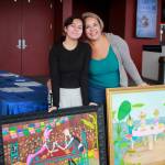 Mother and daughter artist duo Lia Aguirre and Angelica Juarez pose with Juarez paintings at the Arts Alive photo drop off. Photos by Keelin Everly-Lang / the Mirror