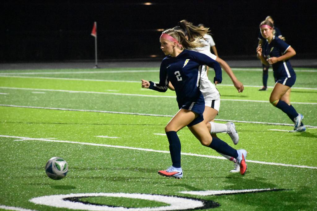 Freshman Katerina Lomats chases down the ball against Federal Way. Ben Ray / The Mirror