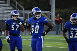 Kevin Ramsey (50), Michal Trumbo (57) and Jeremiah Harrison-Overton (52) look for the call on defense. Ben Ray / The Mirror