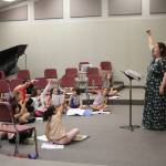 Primo Voce director Brittney Clegg leads her ensemble of 2nd to 4th graders in a warm-up during rehearsal. Photo by Bailey Jo Josie/Sound Publishing.
