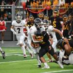 Kentlake defense wraps up Mabin Guillen. Nathan Hyun / The Mirror