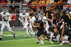 Kentlake defense wraps up Mabin Guillen. Nathan Hyun / The Mirror