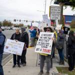 A protester in Federal Way holds a sign stating that a president who turns the military on their own citizens is not a leader but a tyrant, referencing the deployment of National Guard troops in several U.S. cities this year. Photo by Rachel Jones