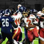 Gabriel Lemelle fights through contact against Todd Beamer. Ben Ray / The Mirror