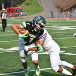 Auburn wide-out Lucas Whitehall-Gilkes takes a hit against the Royals. Ben Ray / Sound Publishing