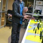 Artist Steve Nagode shows off an example of how the metal Sasquatch sculptures will be crafted, standing next to a diorama of his art proposal for Federal Way. Photo by Keelin Everly-Lang / the Mirror