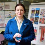 Artist Tsovinar Muradyan shares her proposal for her all-seasons art piece, which will include glowing rock elements like the one she is holding. Her work was recommended by the advisory committee. Photo by Keelin Everly-Lang / the Mirror