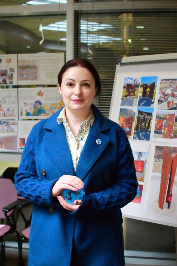 Artist Tsovinar Muradyan shares her proposal for her all-seasons art piece, which will include glowing rock elements like the one she is holding. Her work was recommended by the advisory committee. Photo by Keelin Everly-Lang / the Mirror