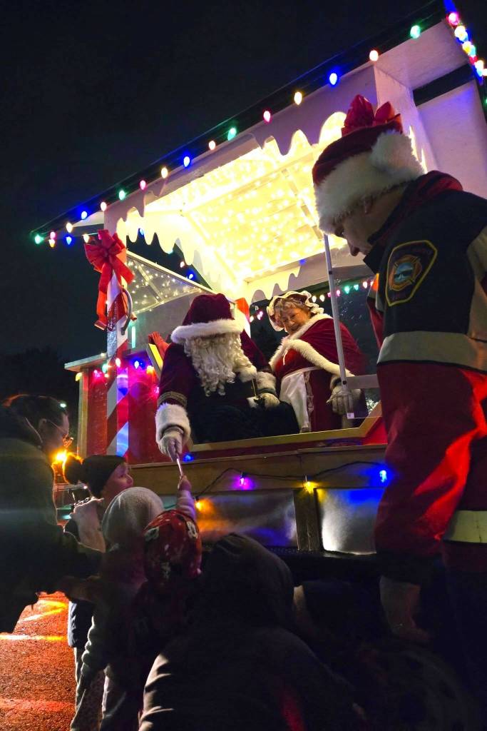 Santa handing out candy to kids on the Santa Parade route. Courtesy photo
