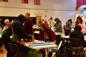 Over 300 families signed up to choose and wrap presents at FW Cares for Kids this year, brightening the holidays for a total of over 1,000 kids. Many volunteers helped in all areas, including childcare, shopping, wrapping, carrying out gifts, Santa photos and more. Photo by Bruce Honda