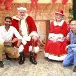 Hospitalists Tuscano Thomson and Andy Nguyen take a break from their work to pose with Santa and Mrs. Claus at St. Francis Hospital in Federal Way. Photo by Keelin Everly-Lang / the Mirror.