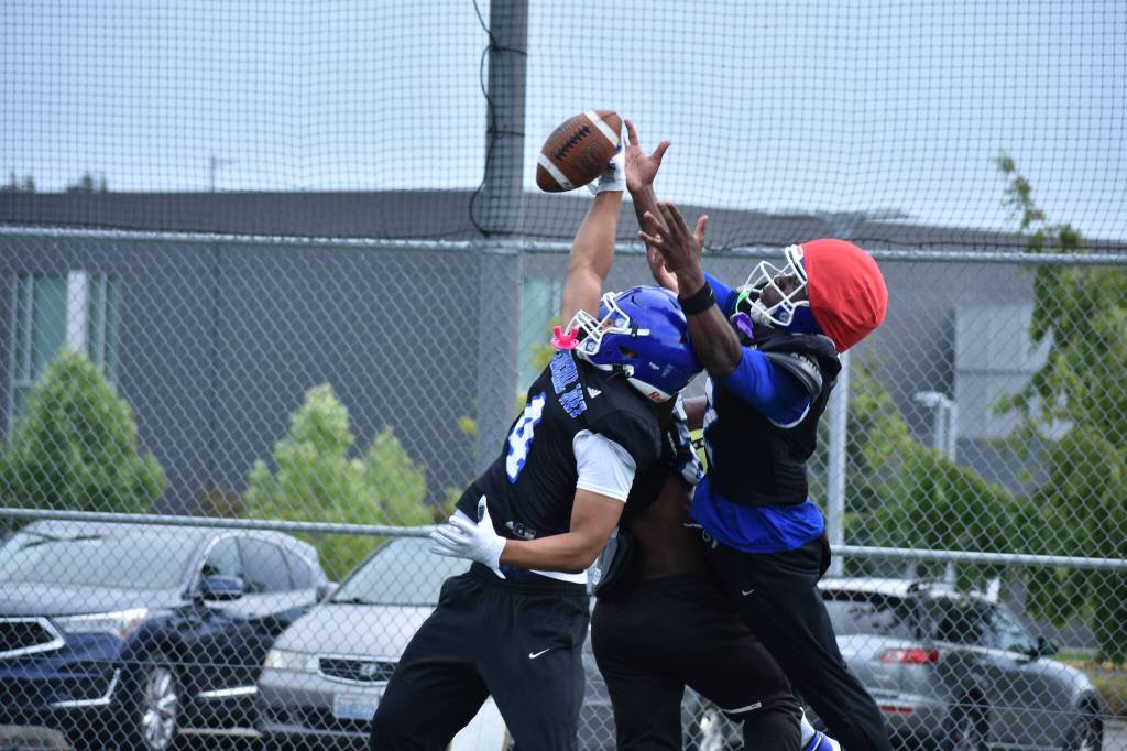 Federal Ways Miles Fuavai makes a one-handed interception during practice.